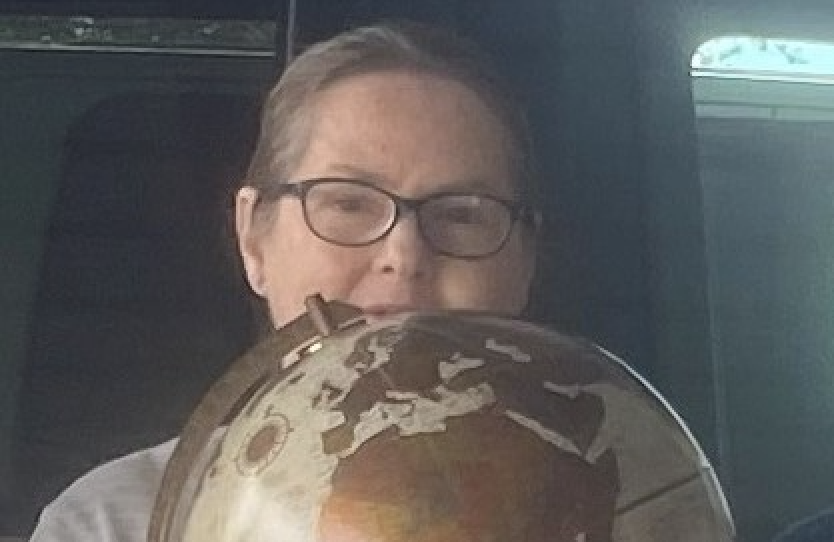 Toni Sammons holding a globe